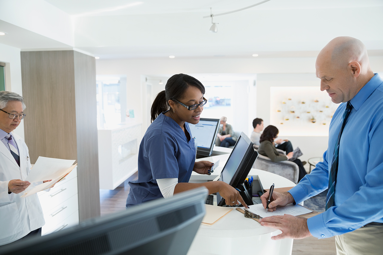 Nurse helping patient with paperwork