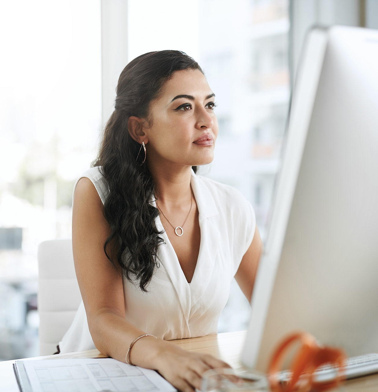 Shot of a young businesswoman using a computer at her desk in a modern office