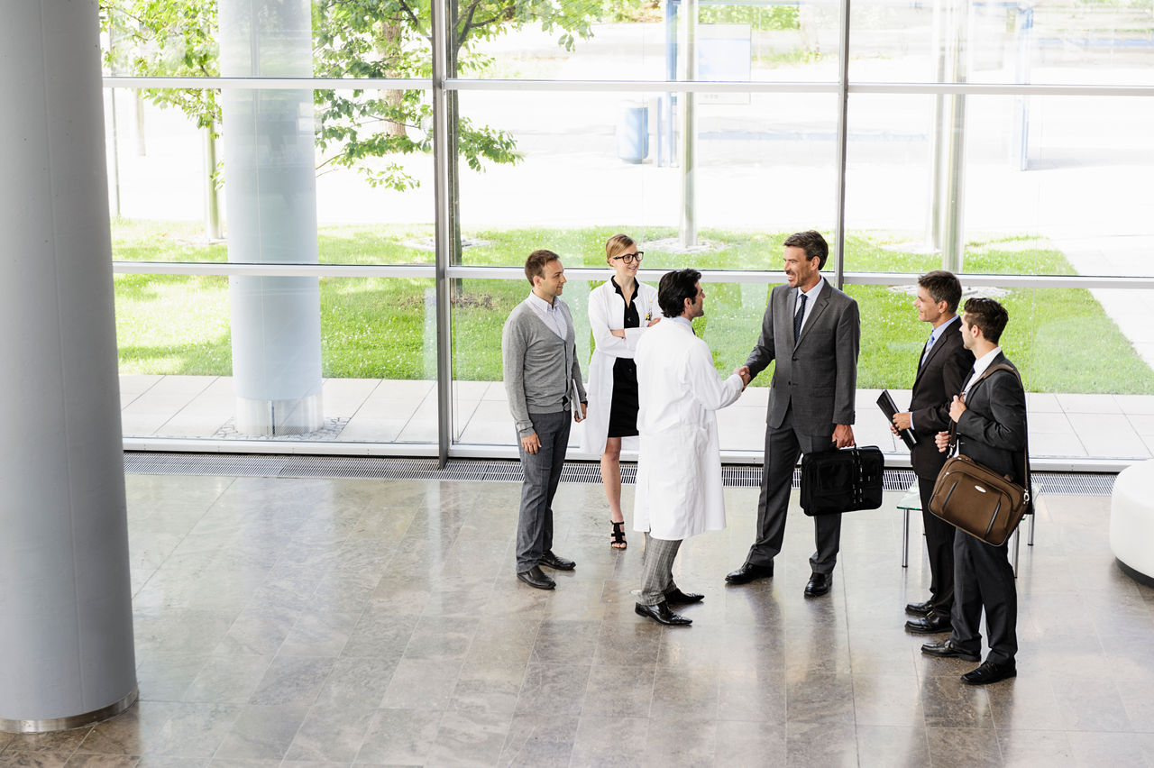 Business people and doctors greeting 