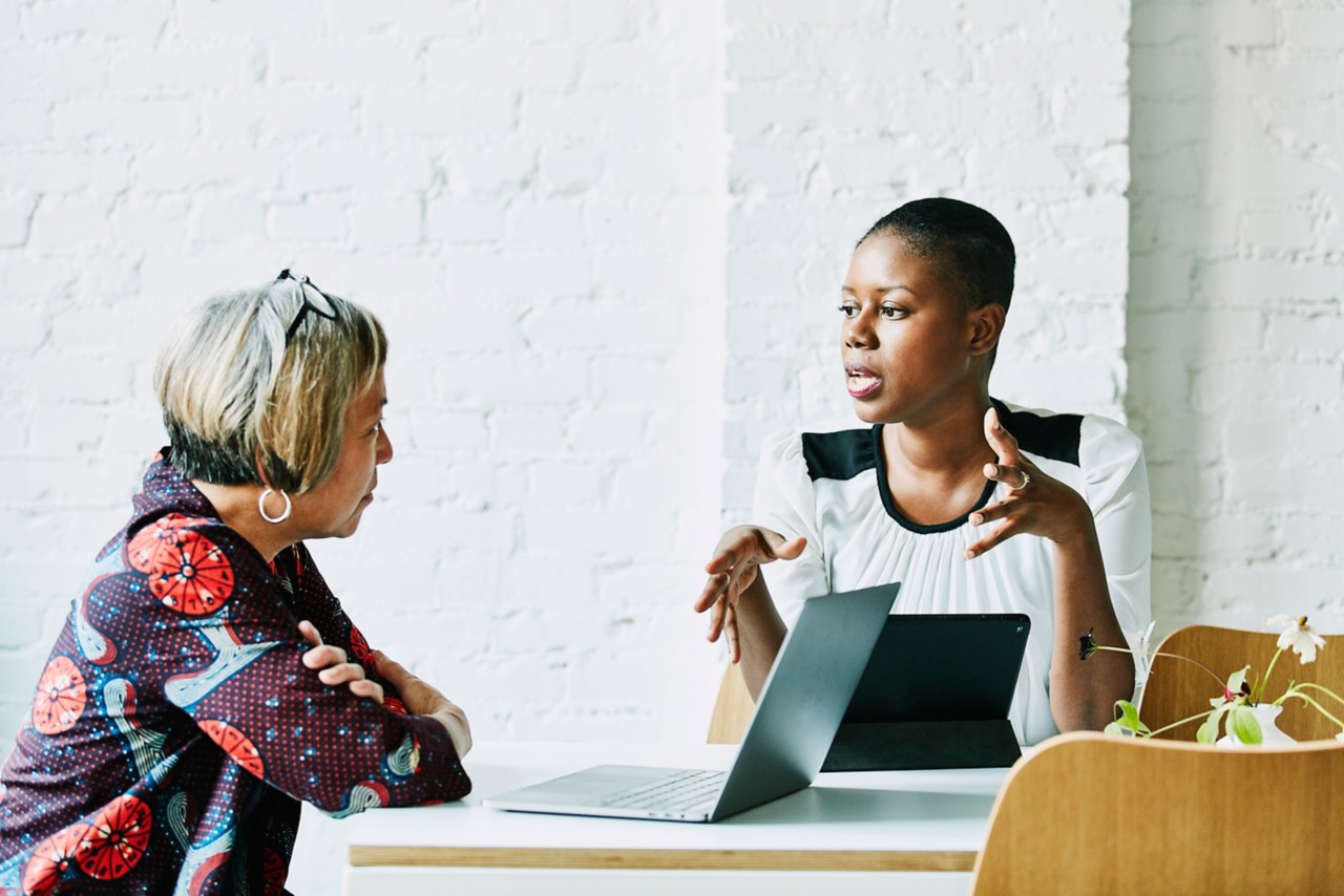 Female financial advisor in discussion with client in office conference room