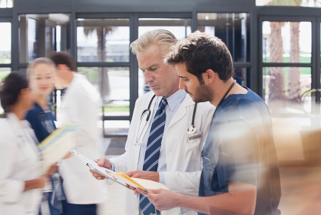 Doctor and nurse reviewing medical record in hospital 