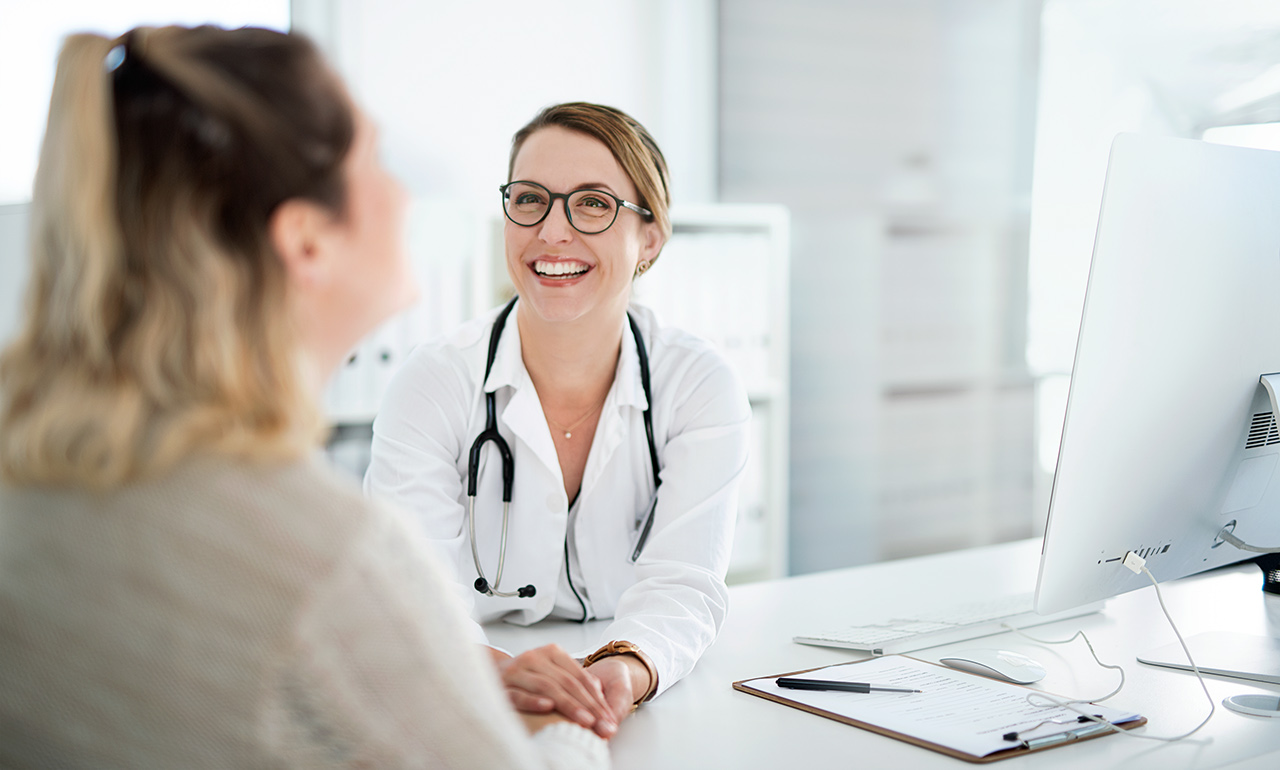 Cropped shot of a female doctor holding a patient's hand in comfort during a consultation inside her office