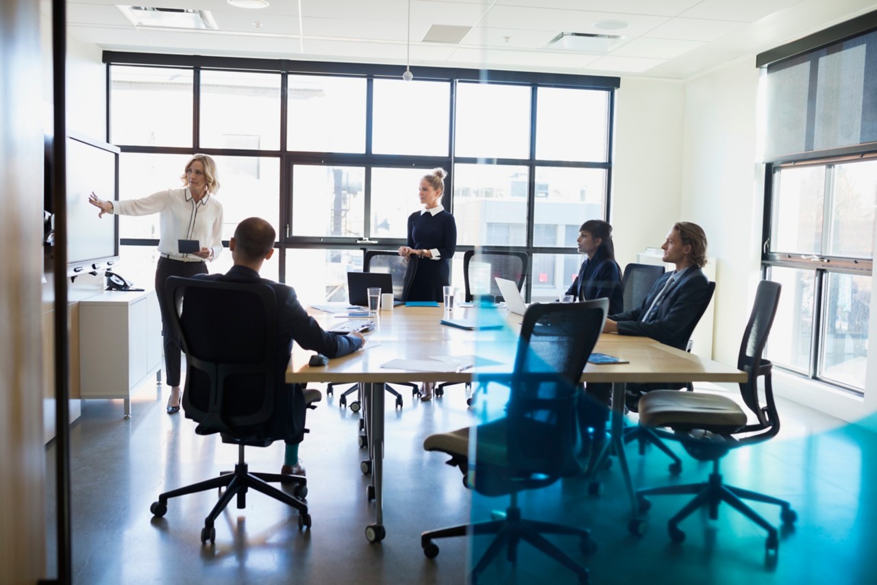 Businesswoman leading meeting in conference room