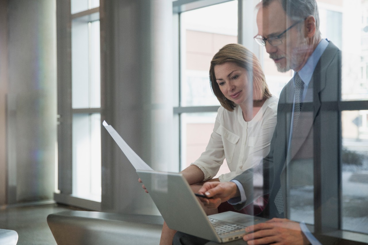 Business man and woman looking at computer