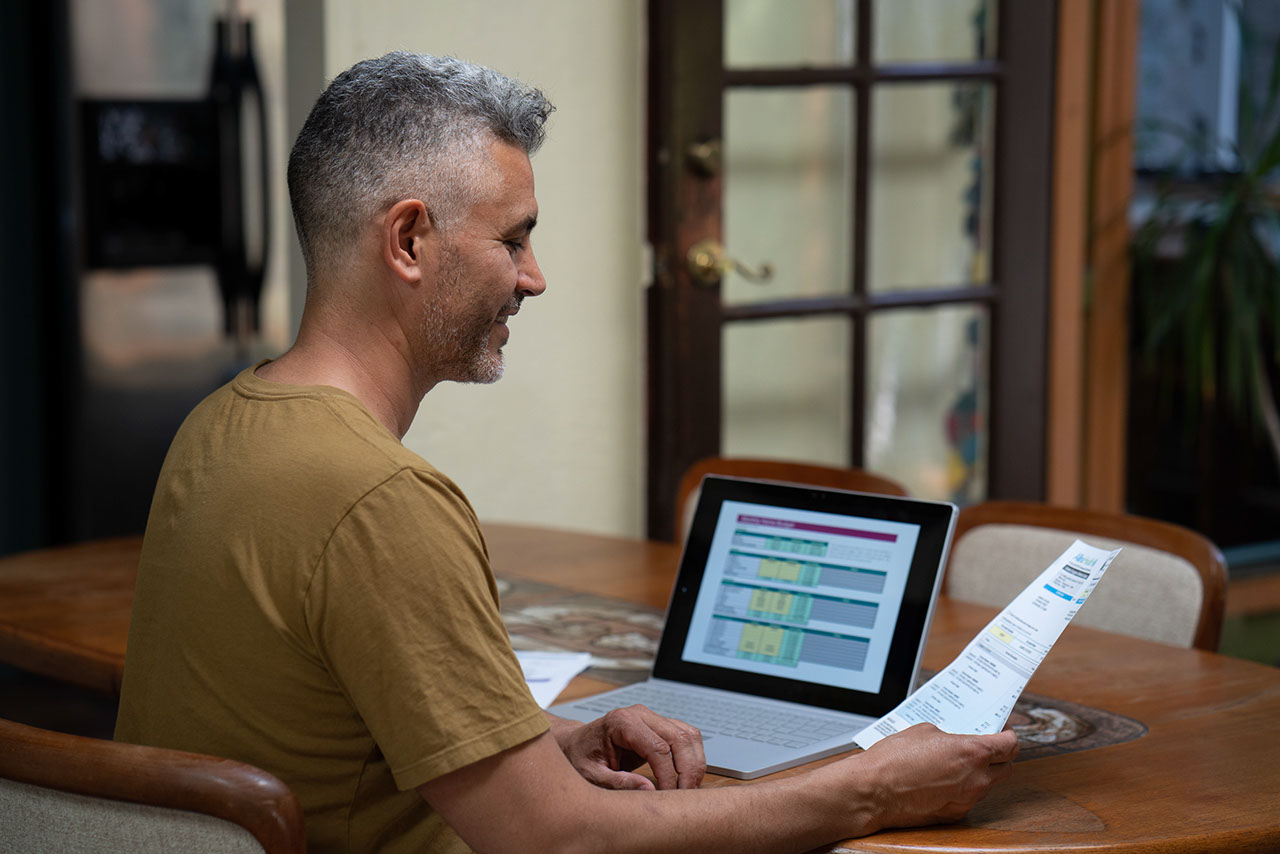 Man at home working on budget