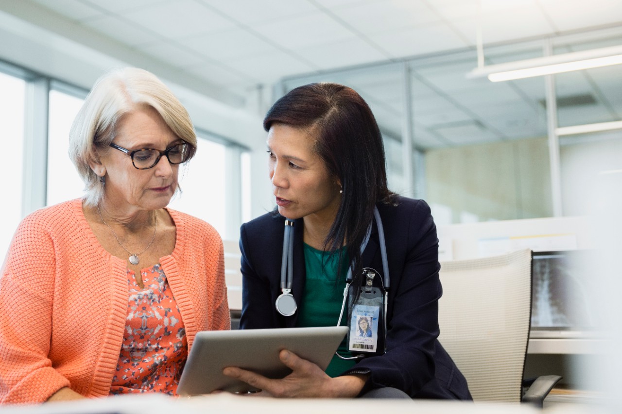 Doctor and patient using digital tablet in clinic