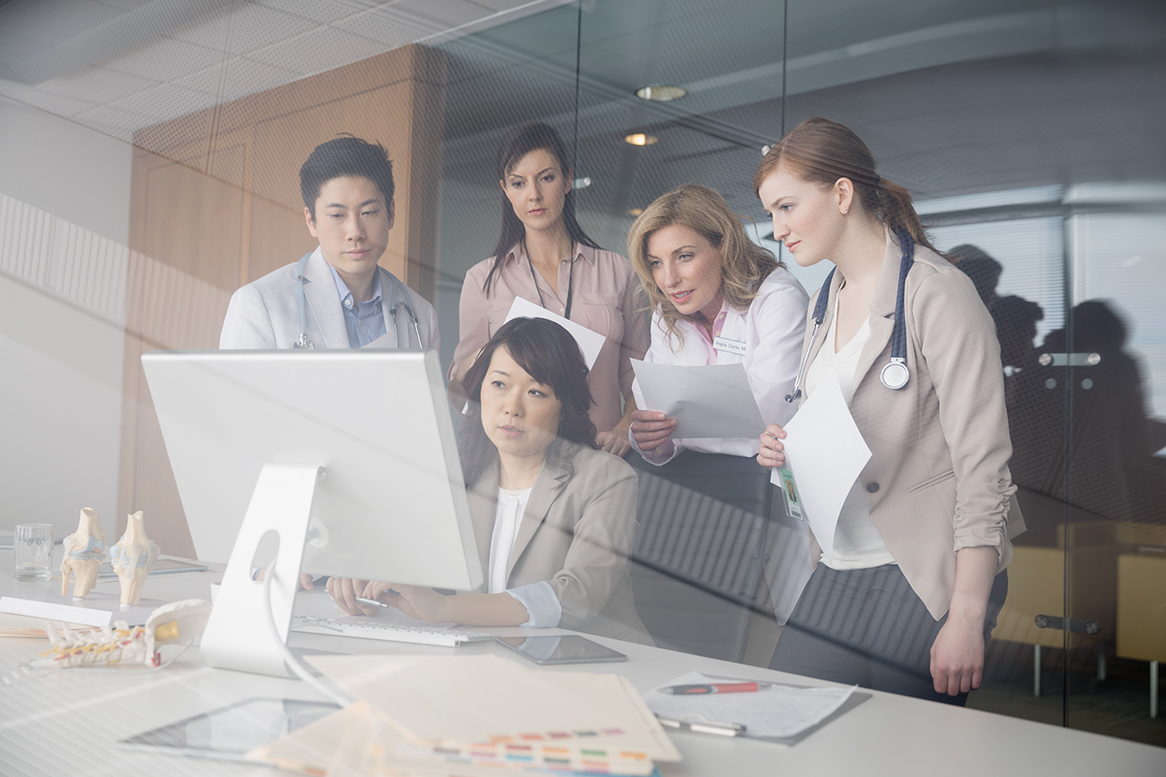 Doctors working at computer in conference room