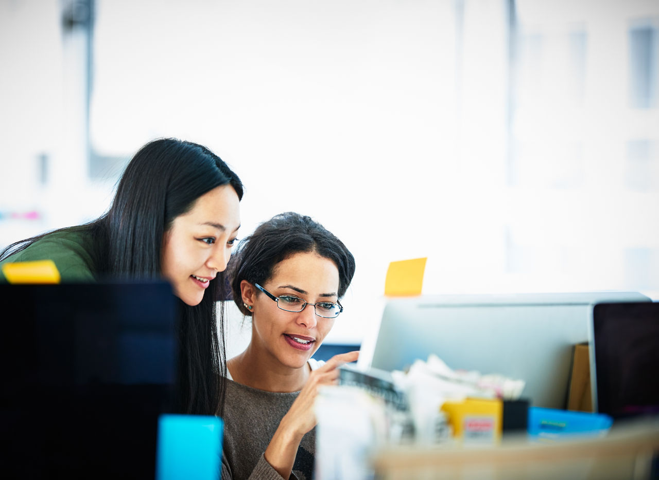 Two businesswomen looking at computer