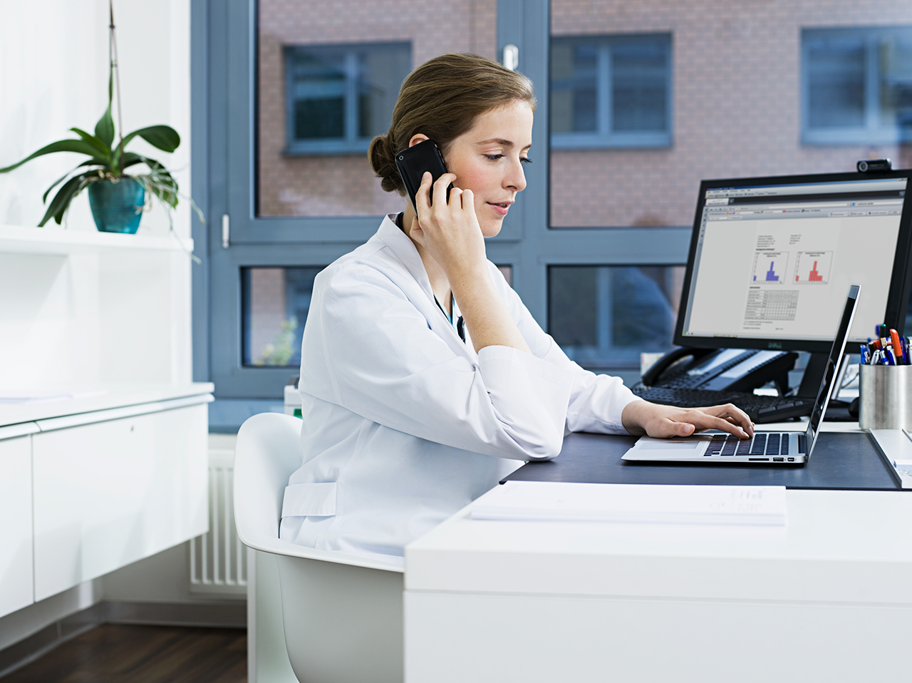 Provider at desk looking at computers