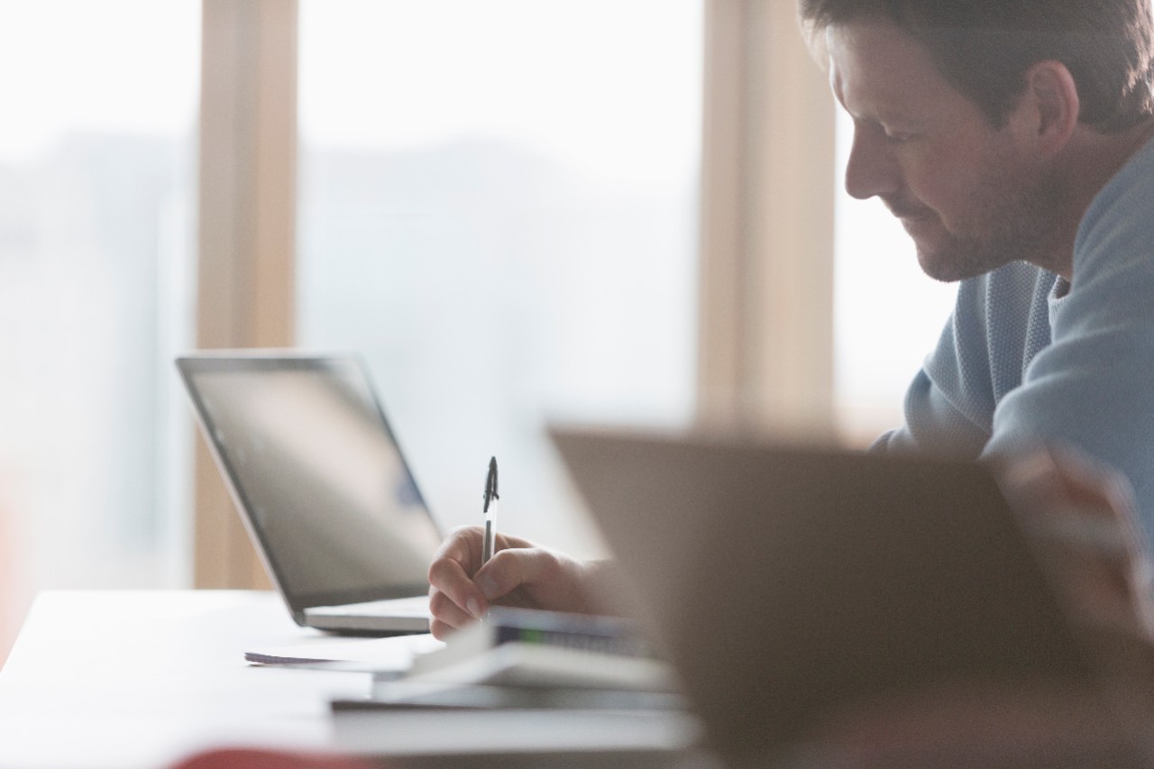 Focused businessman taking notes in meeting