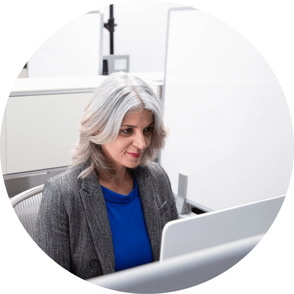 Woman smiling while looking at computer screen